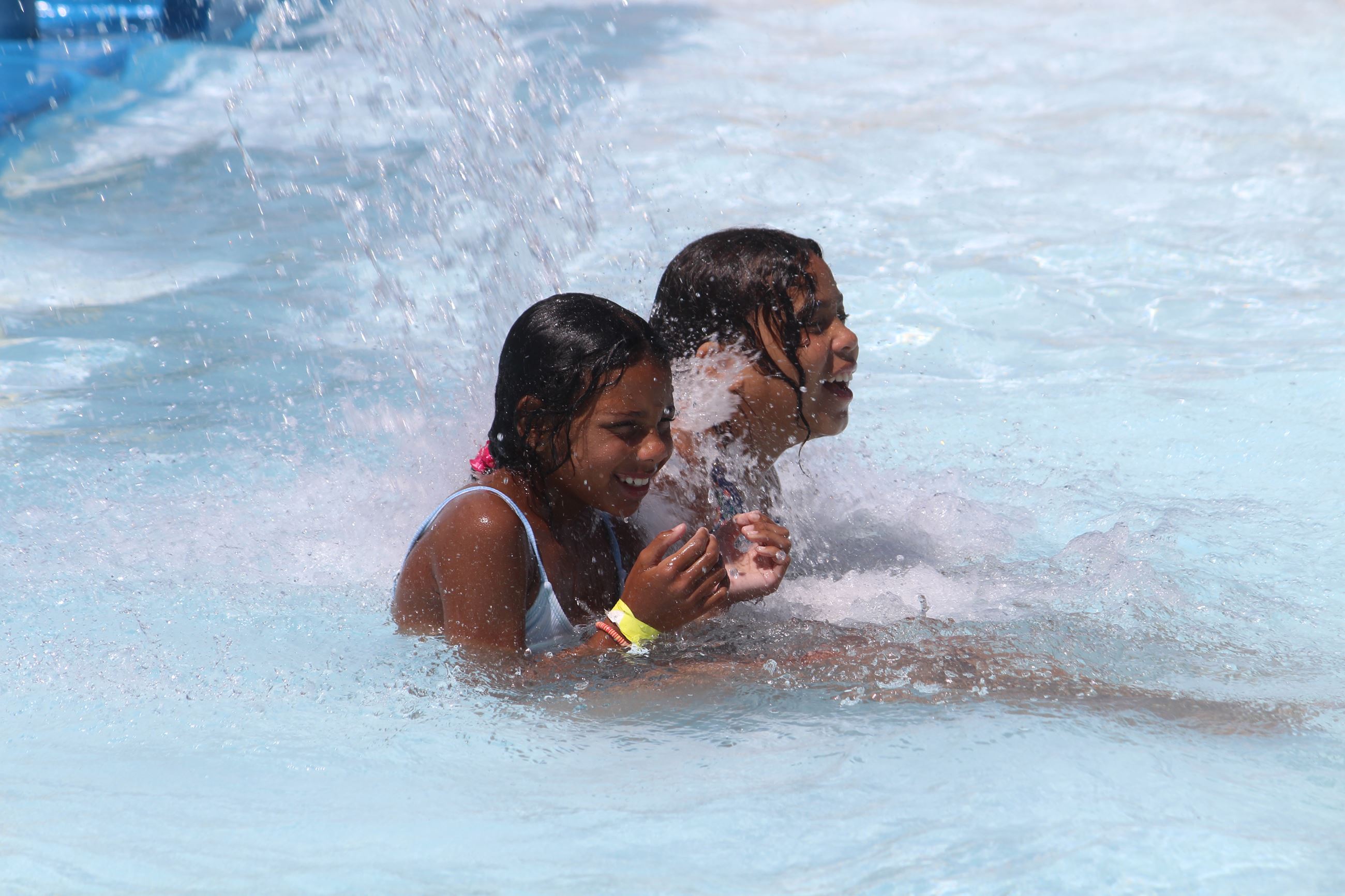 Two young girls enjoy a pool 